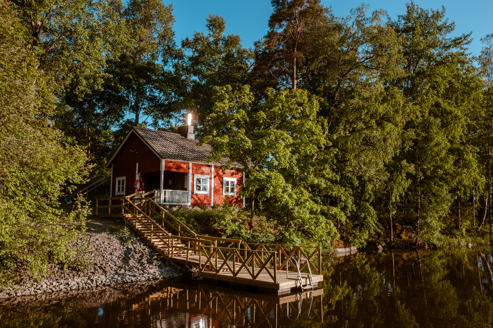 Ilmakuvassa Vanhan pappilan punainen rantasauna ja laituri Herralanvuolteelta kuvattuna.