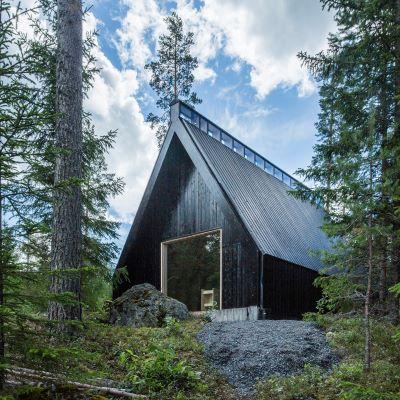 Tervajärven tumman metsäkappelin pääty, taustalla sininen taivas.